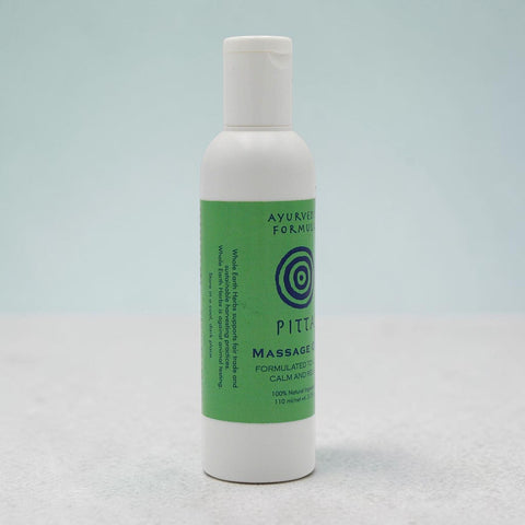 House of Nepal Ayurvedic Pitta Massage Oil in a white bottle with a green label, formulated to calm and restore.