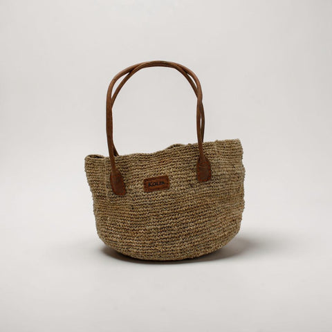 House of Nepal woven jute tote bag with leather handles, natural beige, spacious bucket style, ideal for market, office, or beach.