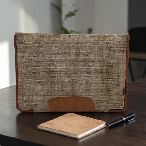 House of Nepal Kolpa 15-inch laptop sleeve made from woven nettle fiber and brown leather accents. Features a unique, sustainable design.