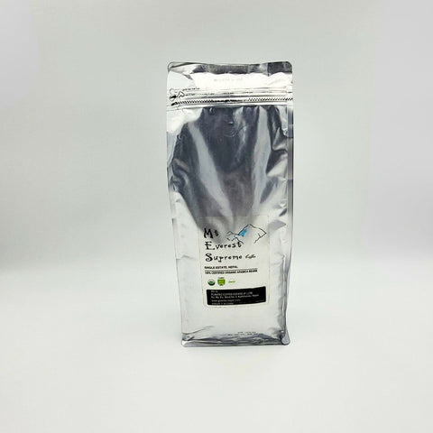 House of Nepal Mt. Everest Supreme Coffee, 1kg bag of 100% certified organic Arabica beans from Nepal, medium-dark roast with chocolate and caramel notes.