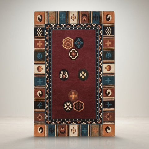 House of Nepal Tibetan style area rug in burgundy with medallion design and geometric border. Hand-knotted wool.