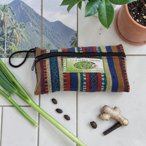 House of Nepal woven pouch with colorful stripes containing 25 Tulsi Herbal Drinks tea bags.