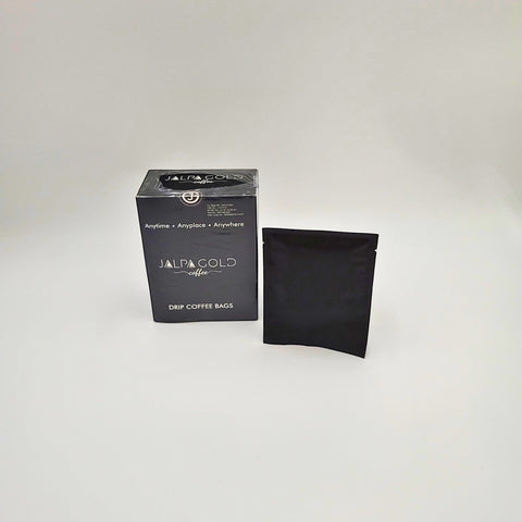 House of Nepal Jalpa Gold Drip Filter Coffee box and a single black drip coffee bag. Micro-ground Arabica coffee for intense flavour.