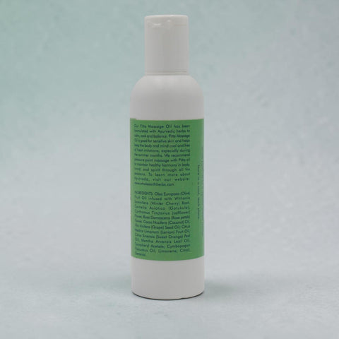 House of Nepal Ayurvedic Pitta Massage Oil bottle with green label listing ingredients like Gotu Kola and rose petals.
