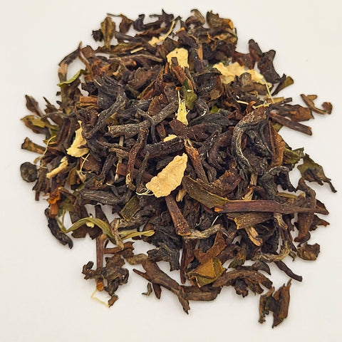 House of Nepal ginger black tea blend with dried ginger pieces and dark tea leaves.