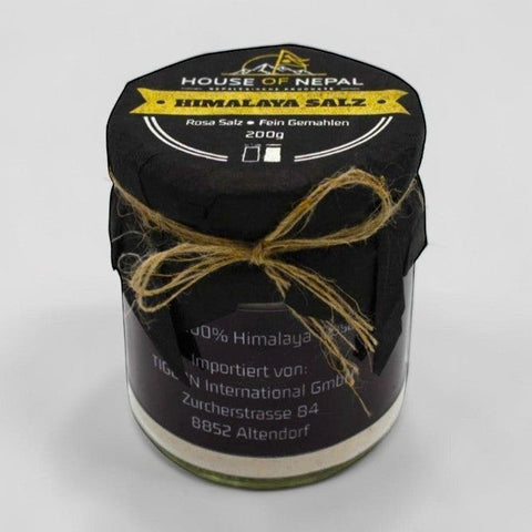 House of Nepal 200g jar of fine pink Himalayan salt, naturally coloured by minerals, ideal for cooking or spa use.