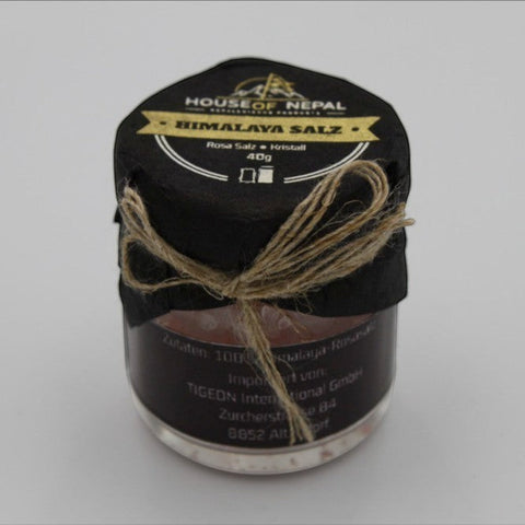 House of Nepal 40g jar of coarse pink Himalayan crystal salt, tied with twine.